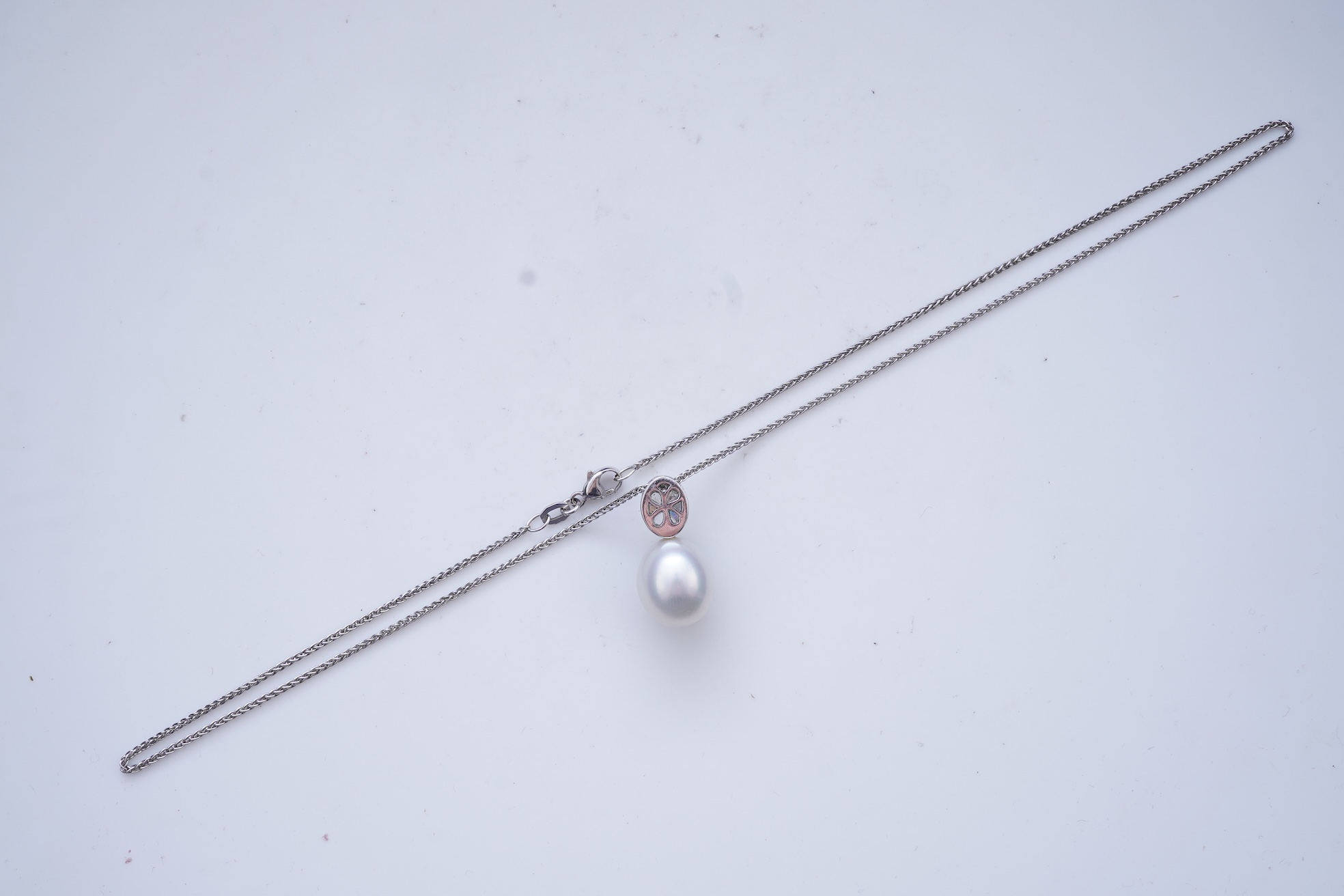 A cultured pearl and diamond pendant